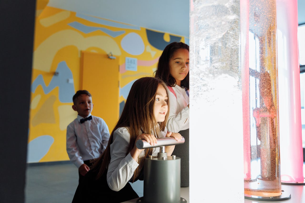 Children engage in a science experiment with colored liquids at school.